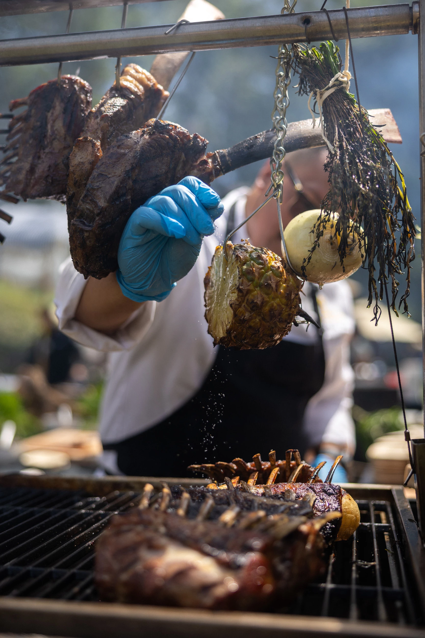 a person cooking meat on a grill