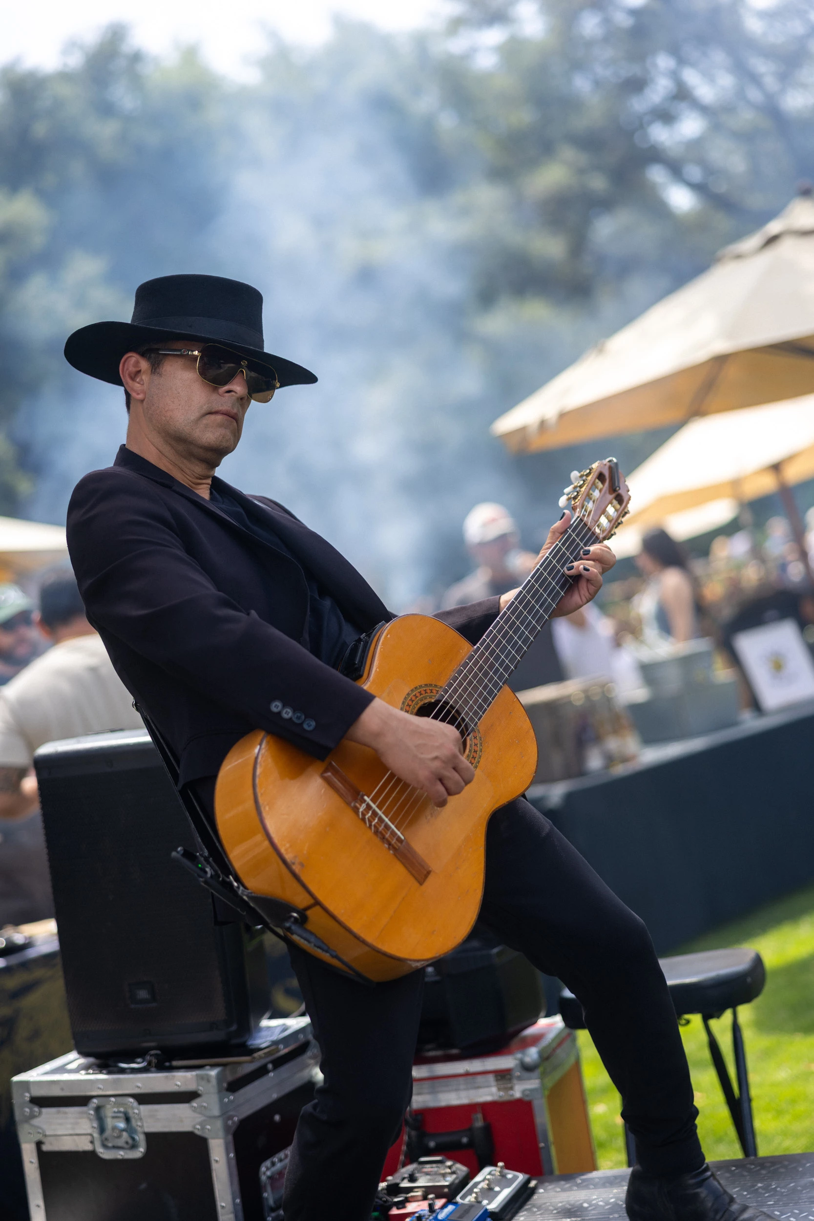 a man in a hat playing a guitar