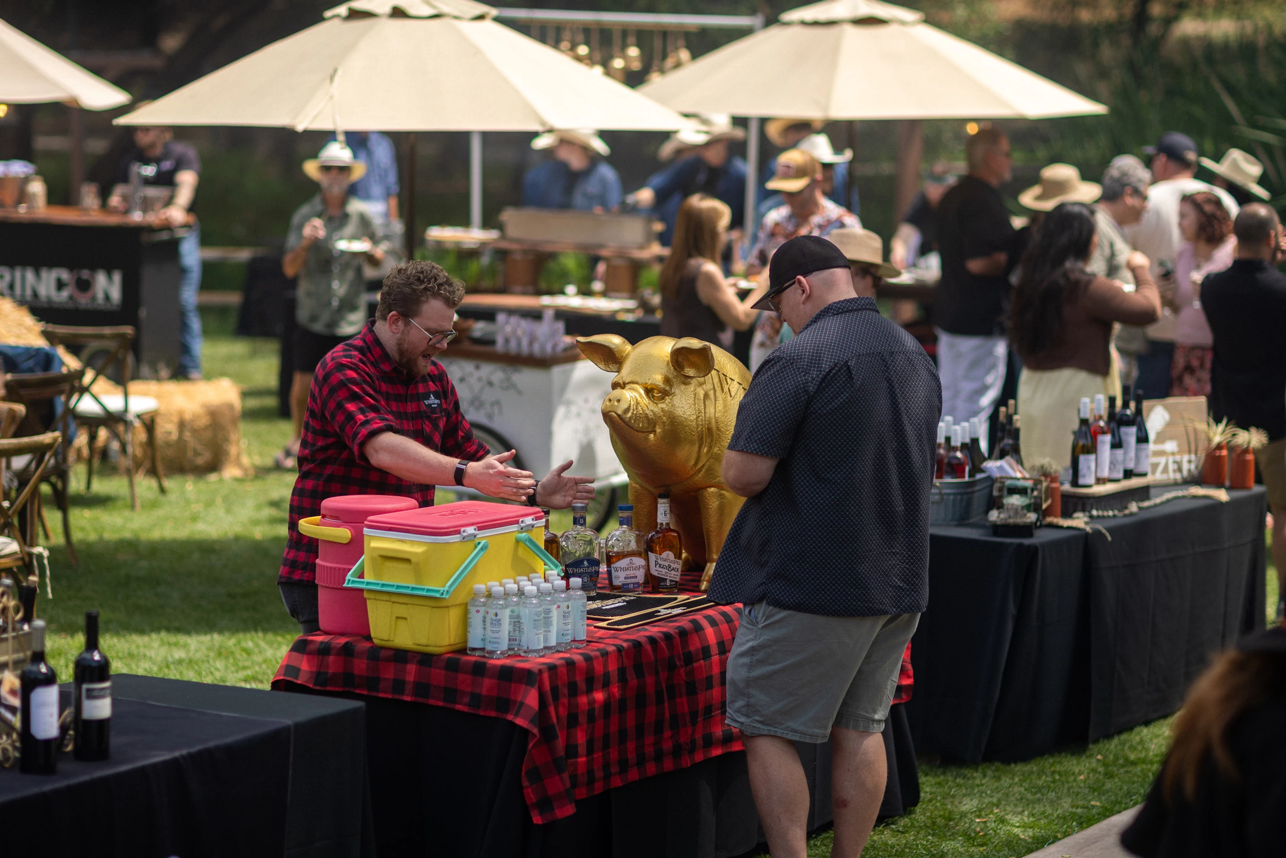 a man standing next to a table with a pig statue