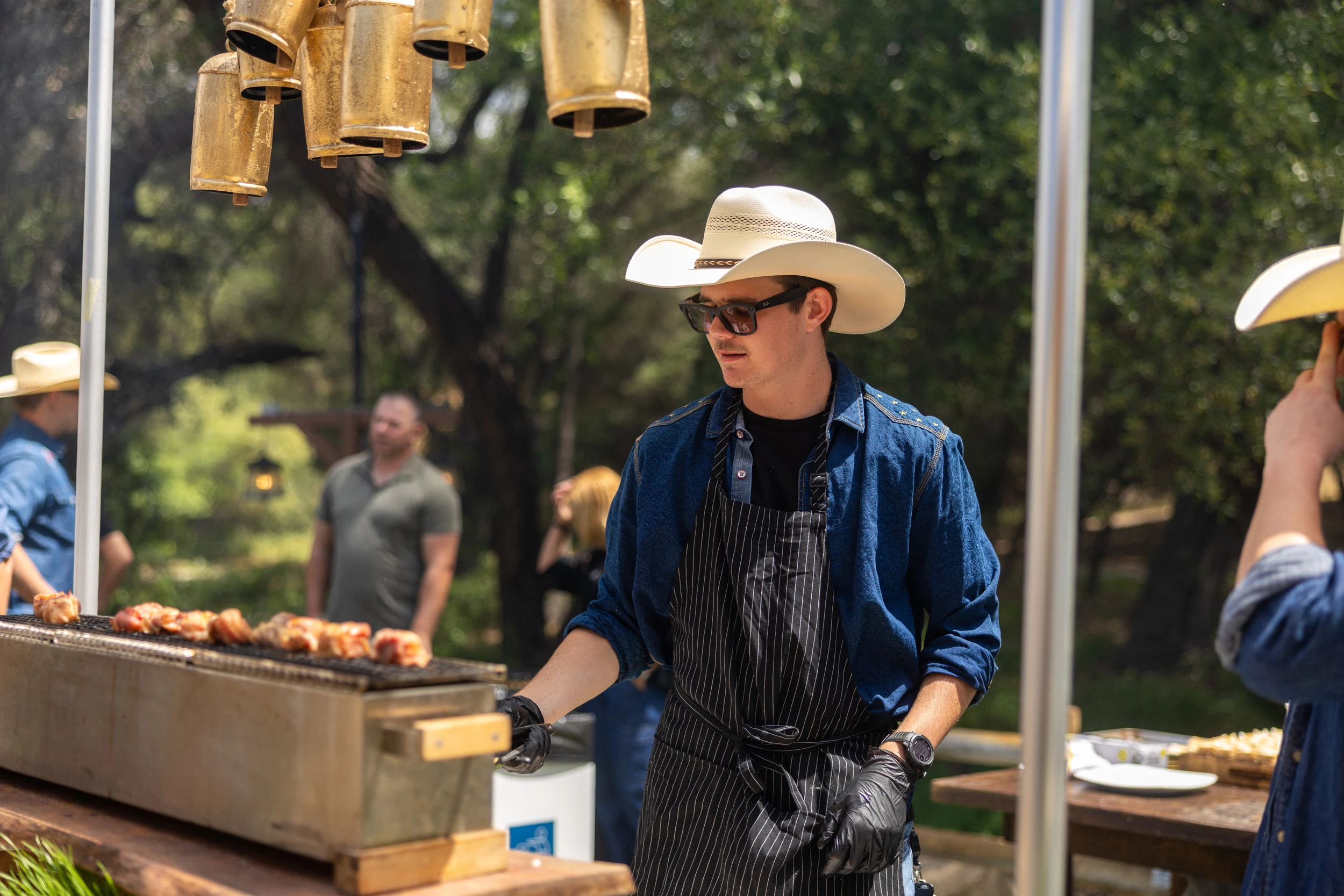 a man wearing a cowboy hat and apron