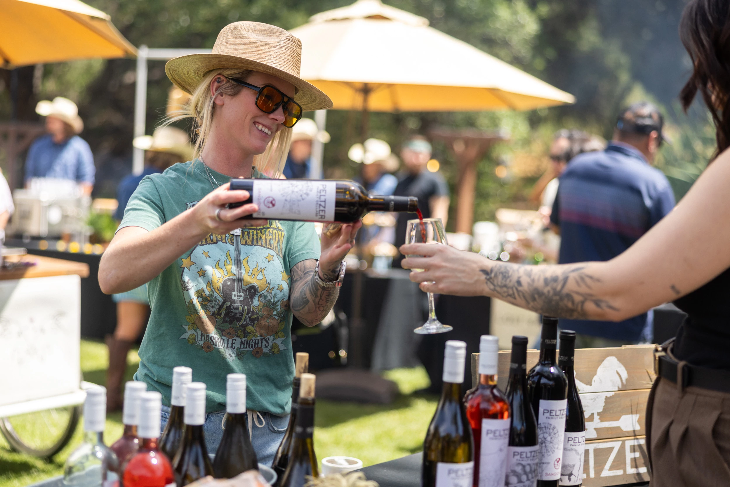 a woman pouring wine into a glass