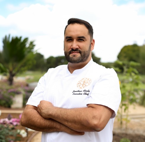 a man in a white shirt with his arms crossed