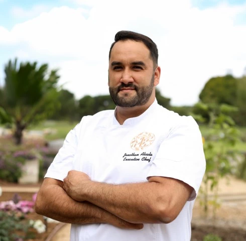 a man in a white shirt with his arms crossed