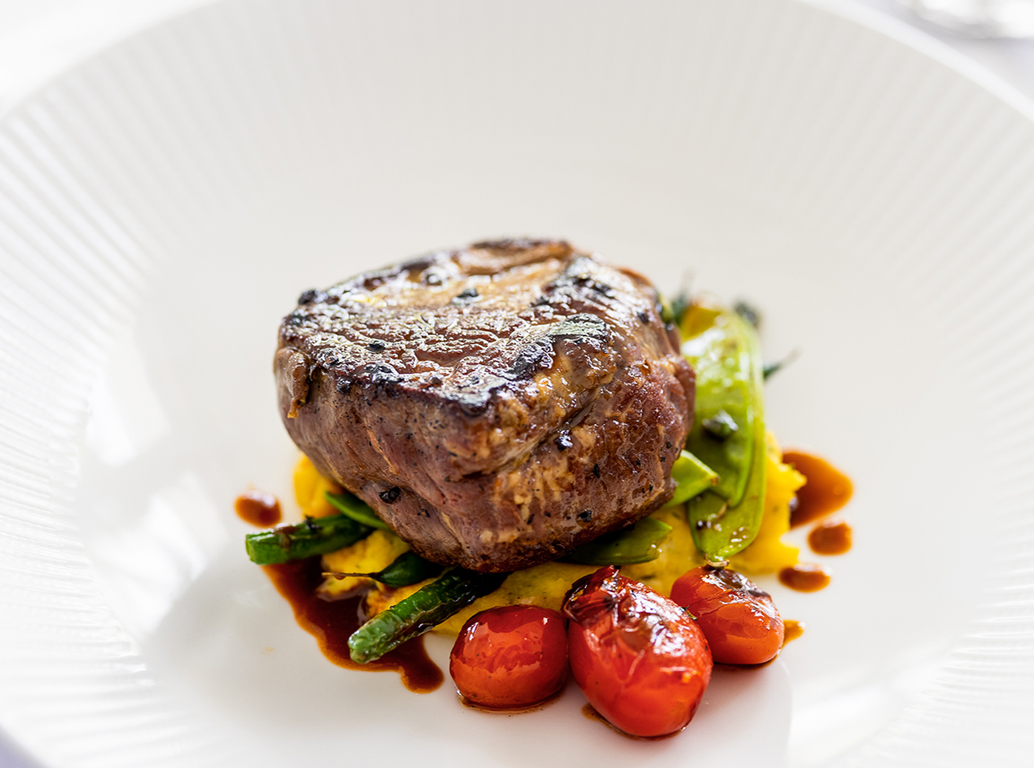 a plate of food with a piece of meat and vegetables