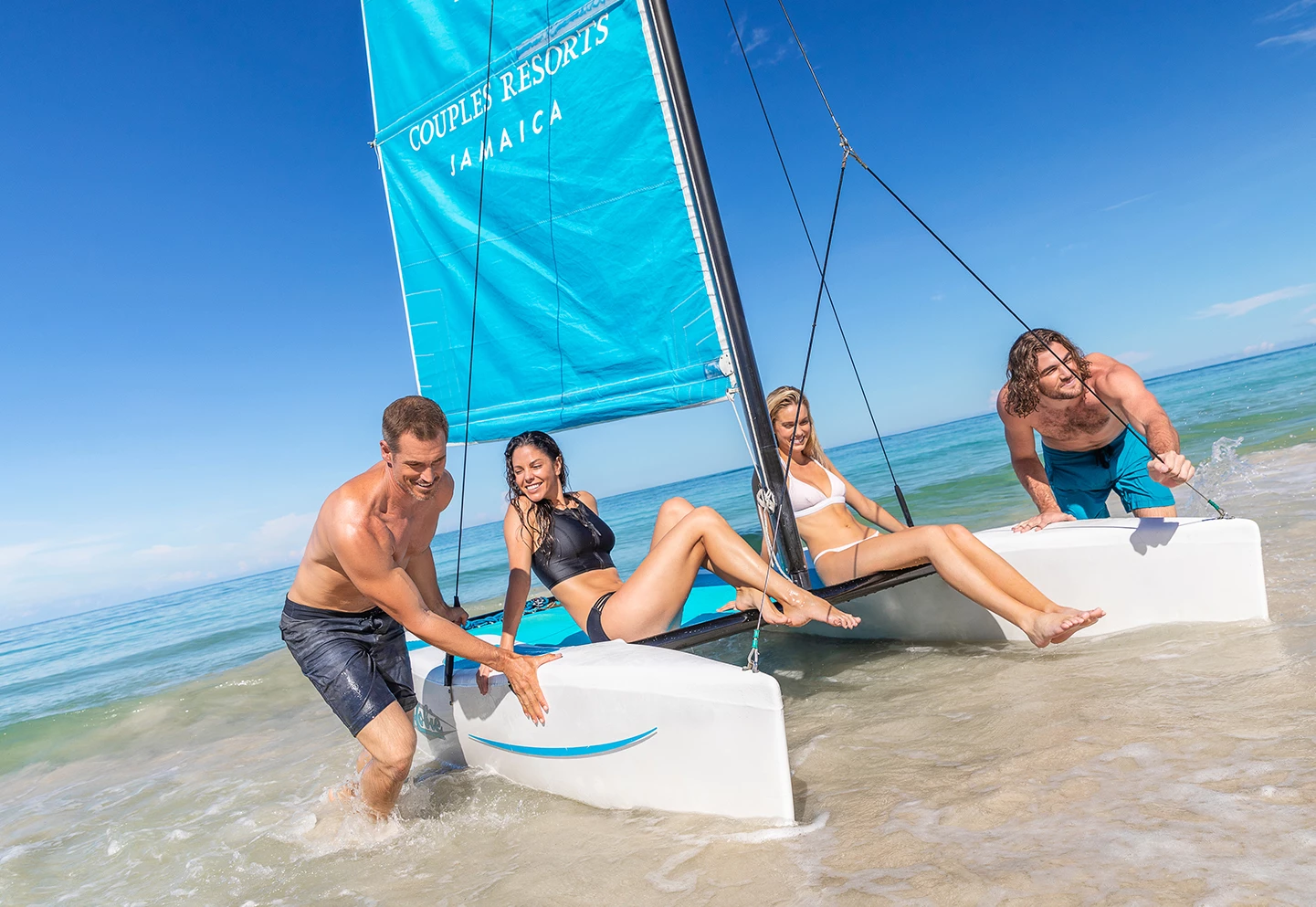 a group of people on a sailboat in the water