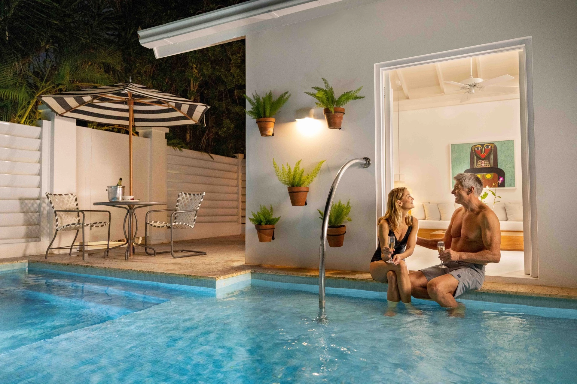 a man and woman sitting in a pool