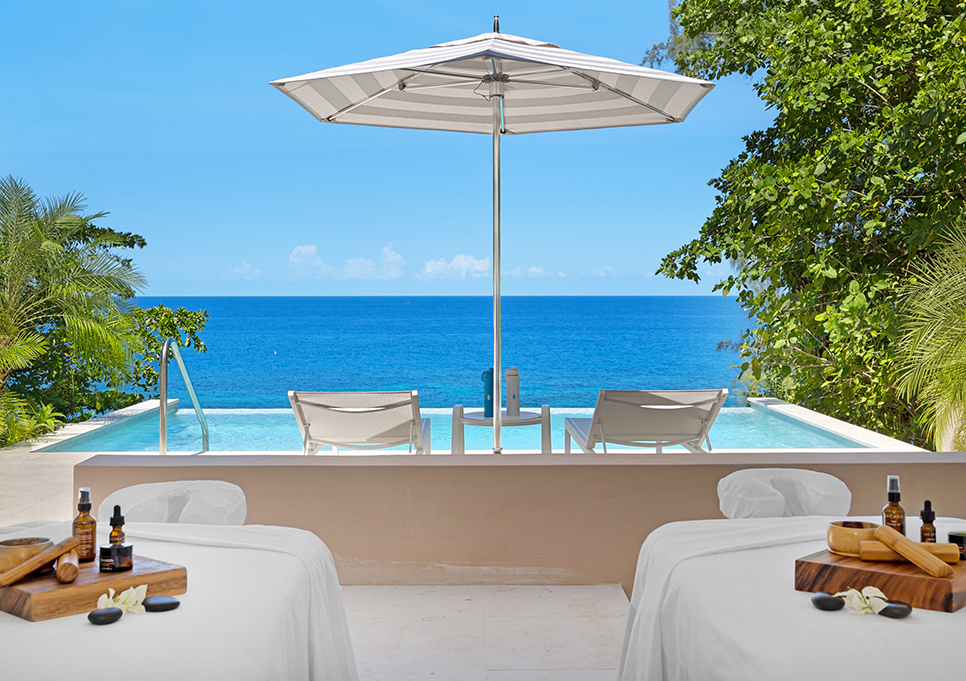 a pool with a deck and chairs and a umbrella