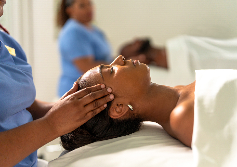 a woman lying on a bed with her eyes closed