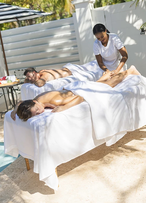 a group of people lying on massage beds