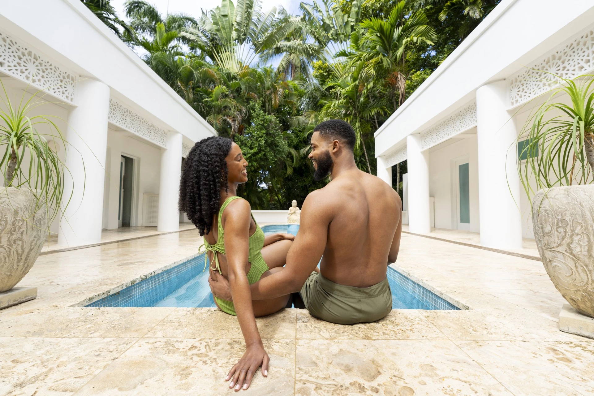 a man and woman sitting in a pool