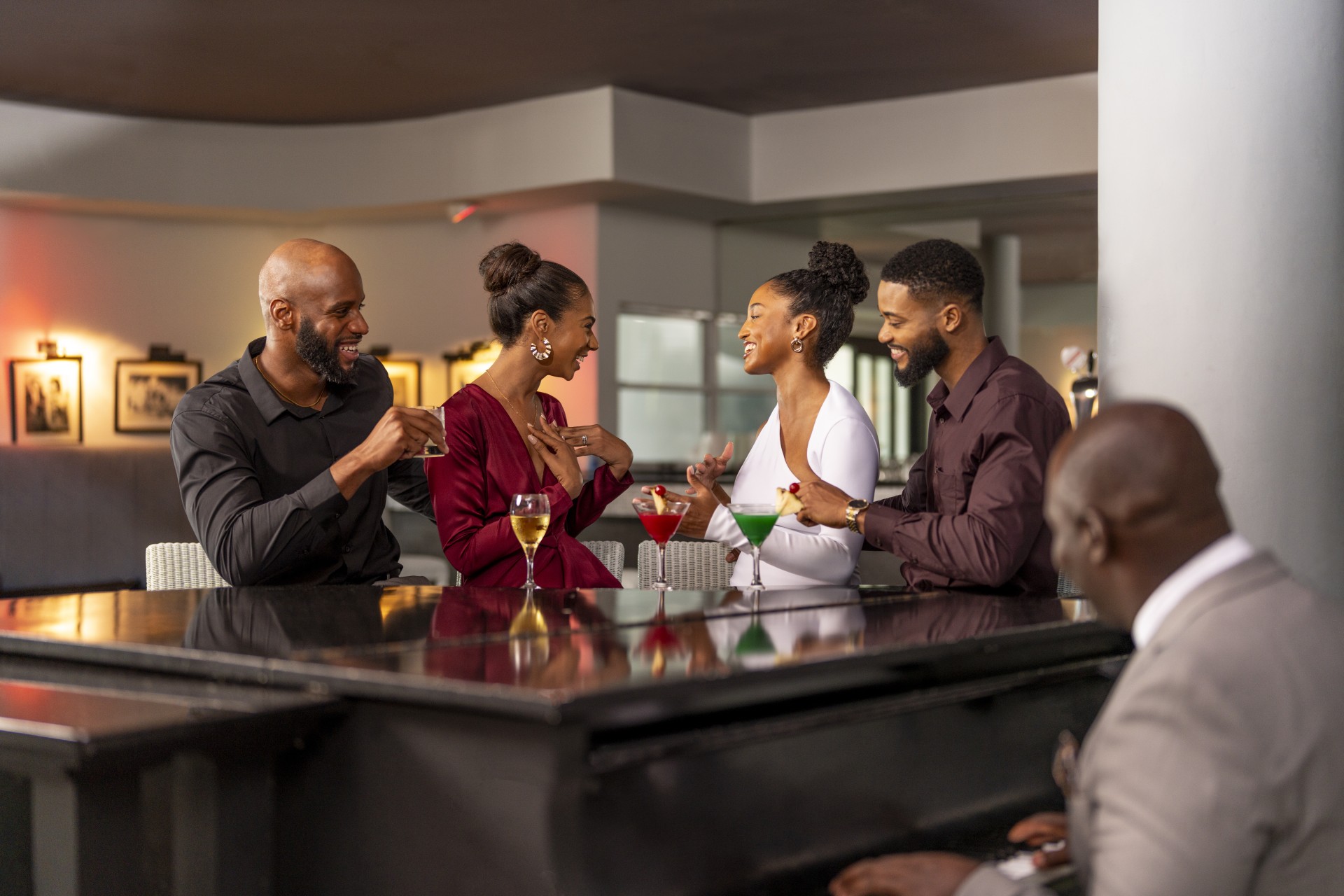 a group of people sitting at a bar