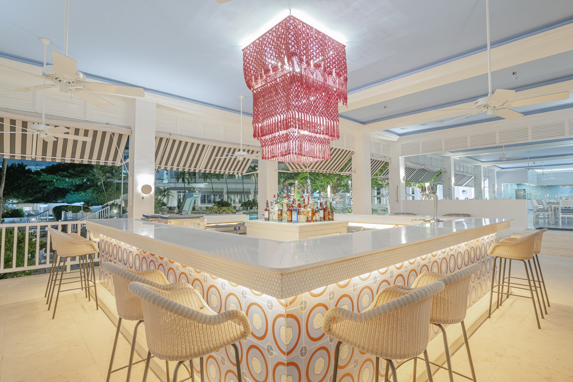 a bar with a chandelier and chairs