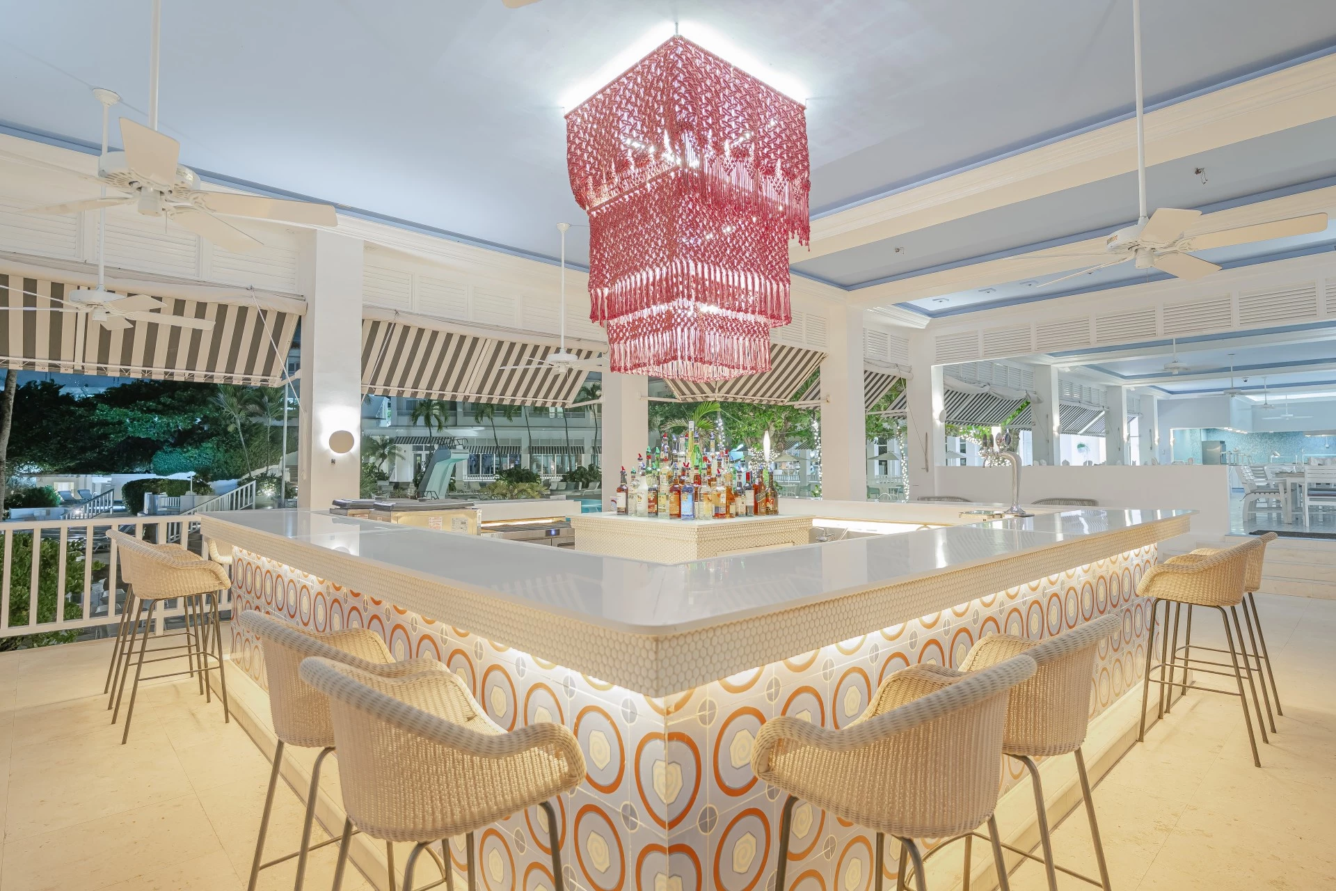 a bar with a chandelier and chairs