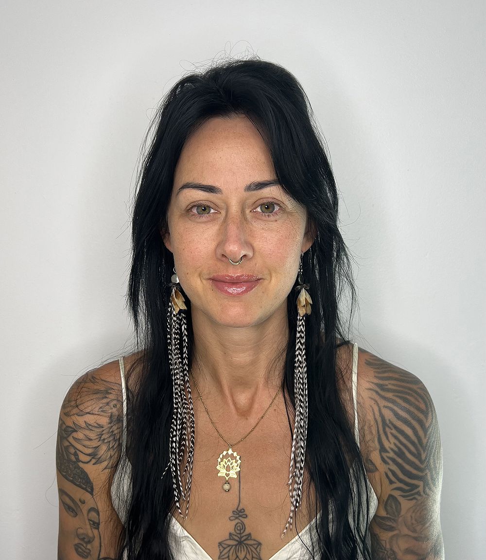 a woman with tattoos and a nose ring