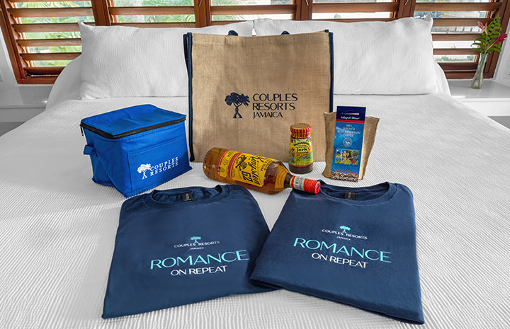 a group of t-shirts and a bag with a bottle of juice and a bag with a wood frame