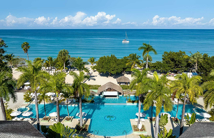 a swimming pool with palm trees and a boat in the water