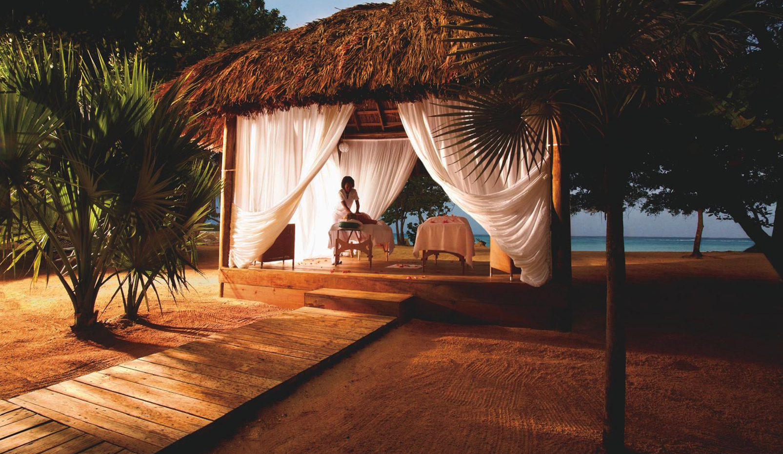 a woman getting a massage on a beach