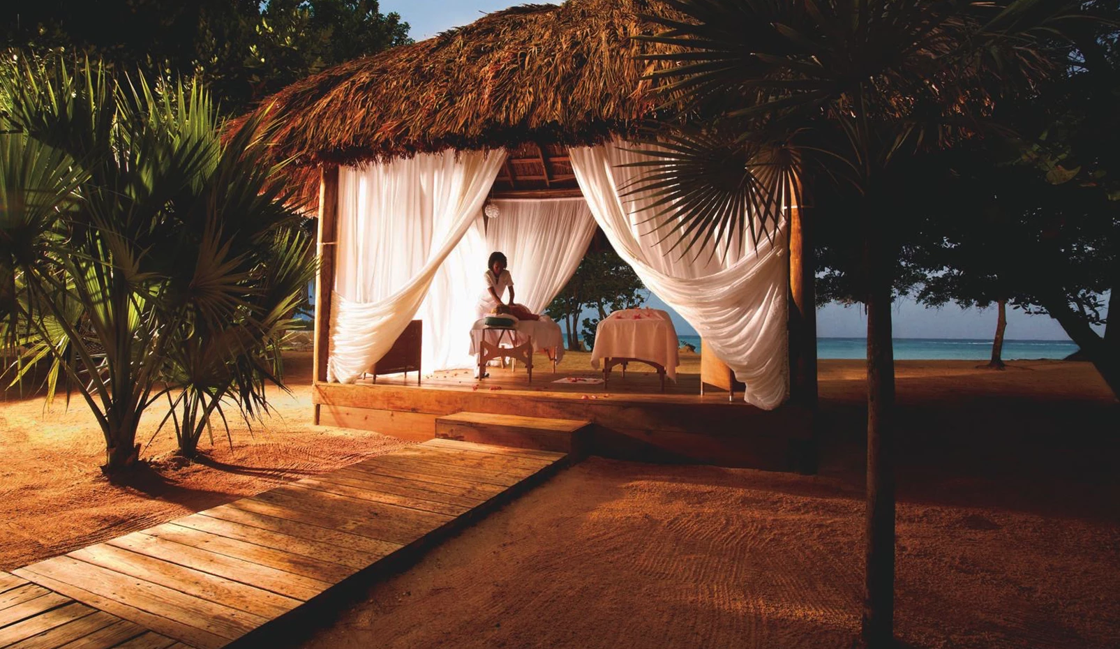 a woman getting a massage on a beach
