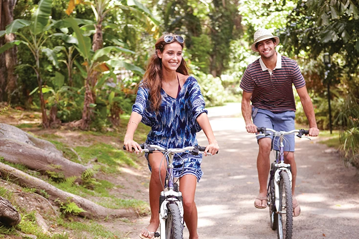 a man and woman riding bikes
