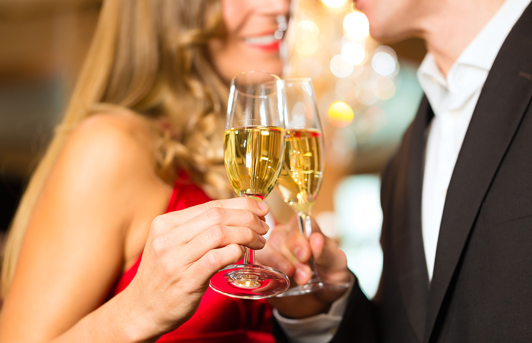 a man and woman holding wine glasses