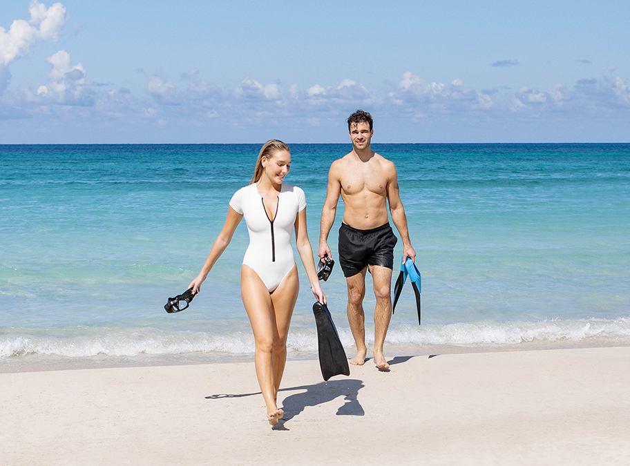 a man and woman walking on a beach