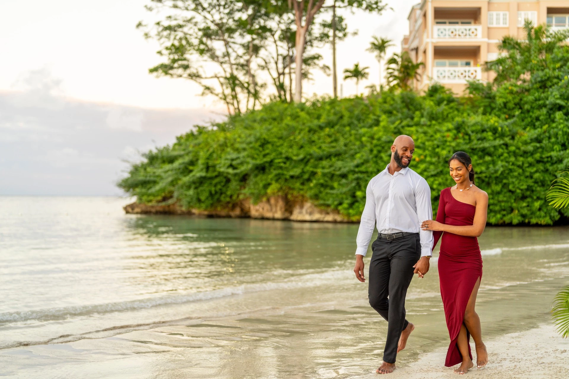 a man and woman walking on a beach