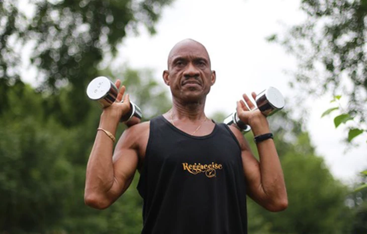 a man lifting weights outside
