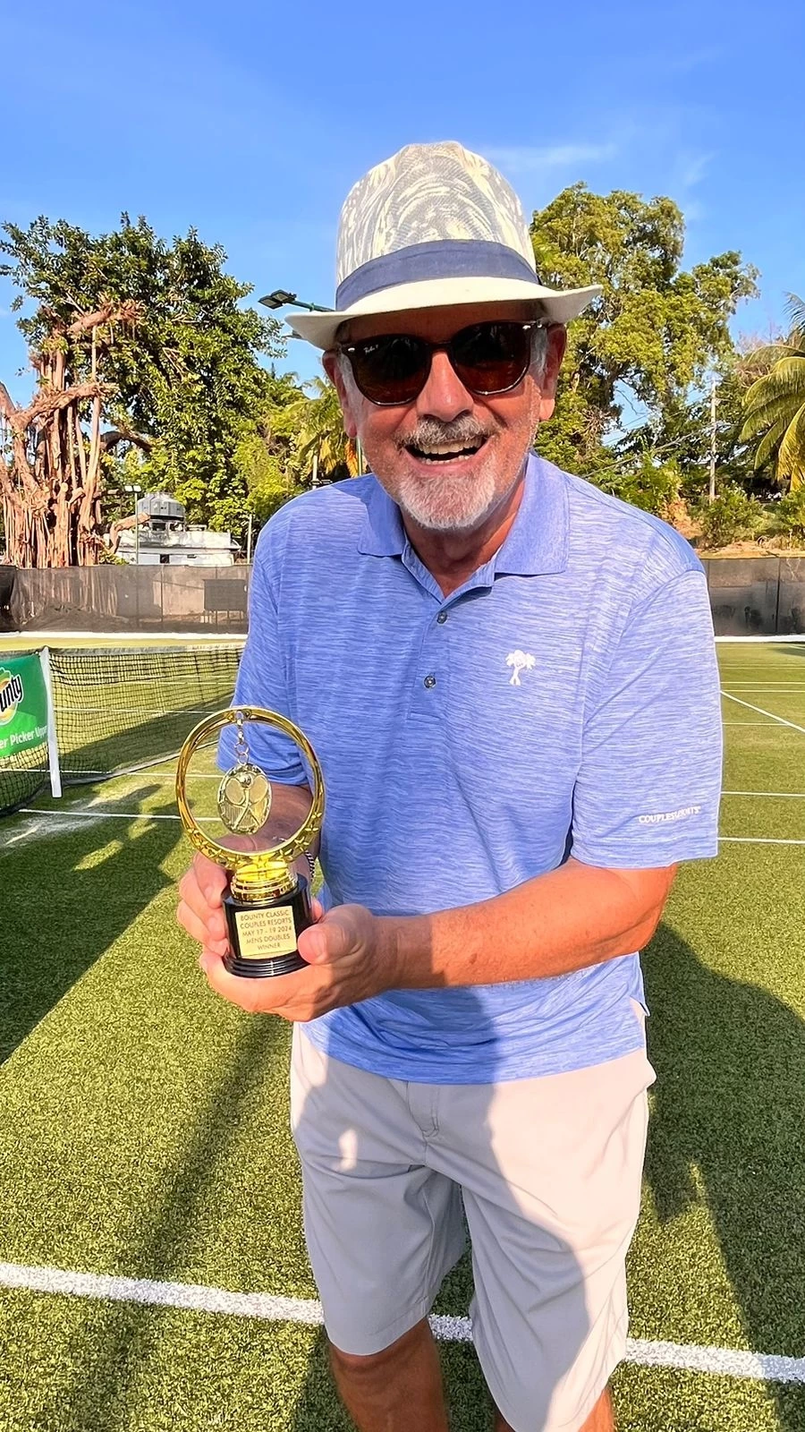 a man holding a trophy