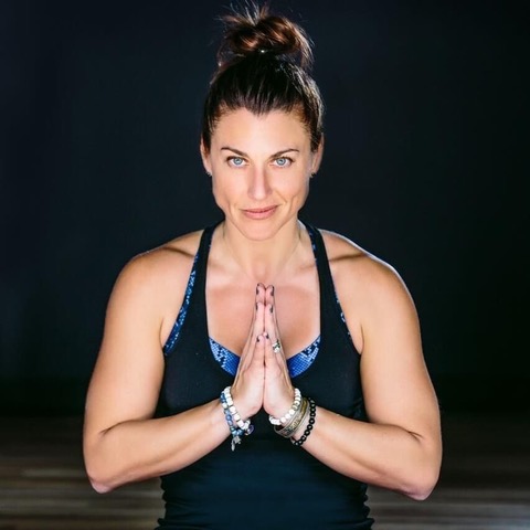 a woman with her hands together in prayer
