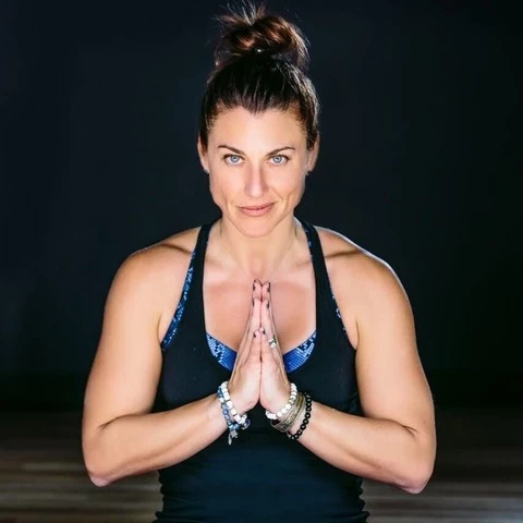 a woman with her hands together in prayer