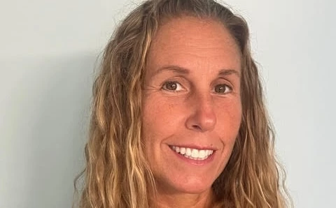 a woman with blonde hair smiling