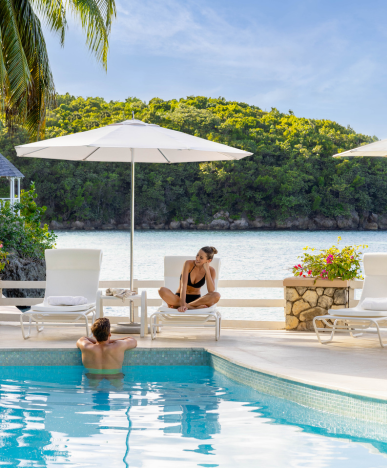 a man and woman sitting in a pool