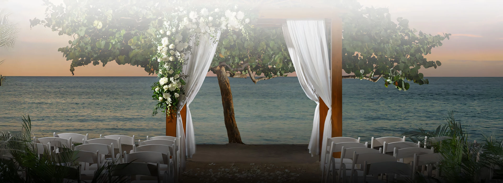 a wedding ceremony with white chairs and flowers