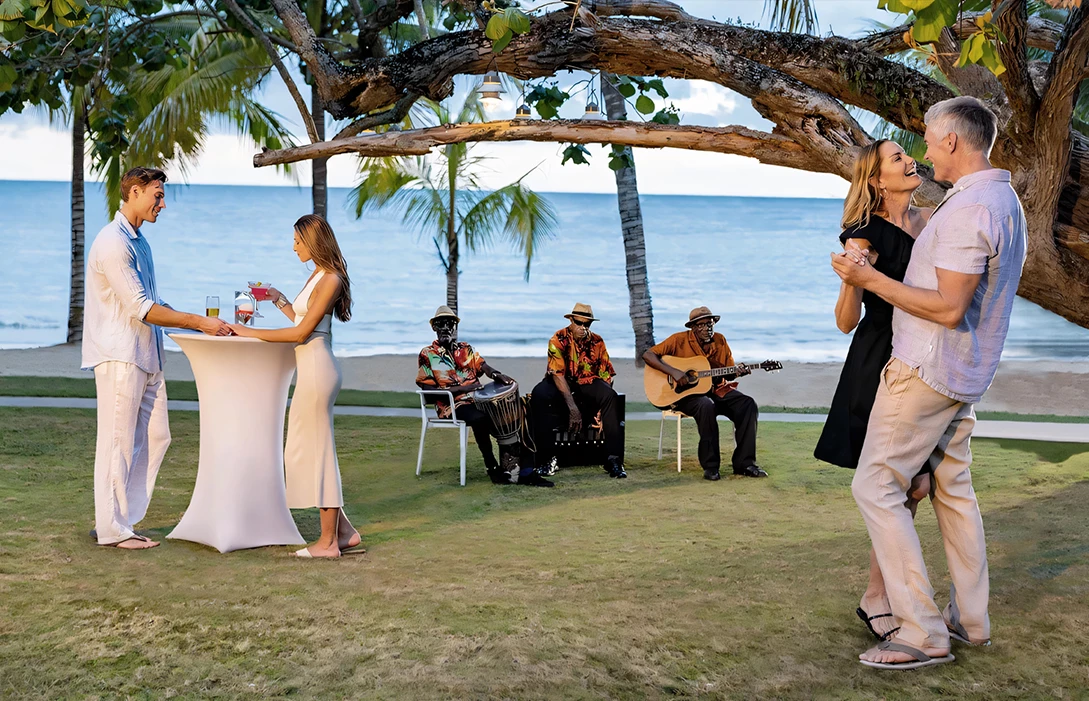 a group of people playing instruments on a beach