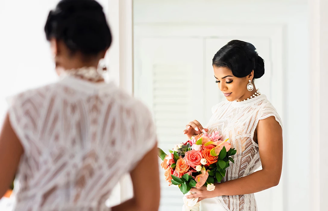 a woman in a white dress holding a bouquet of flowers