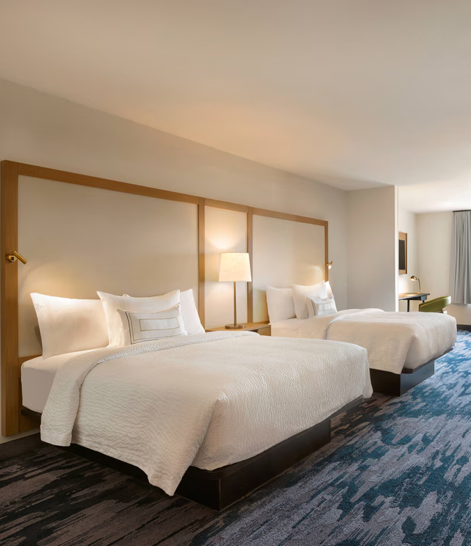 a hotel room with two beds