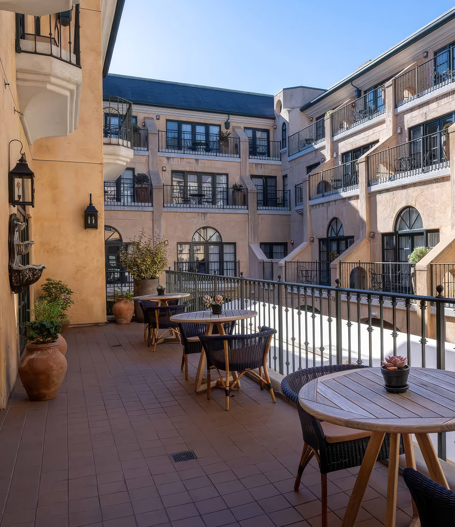 a patio with tables and chairs