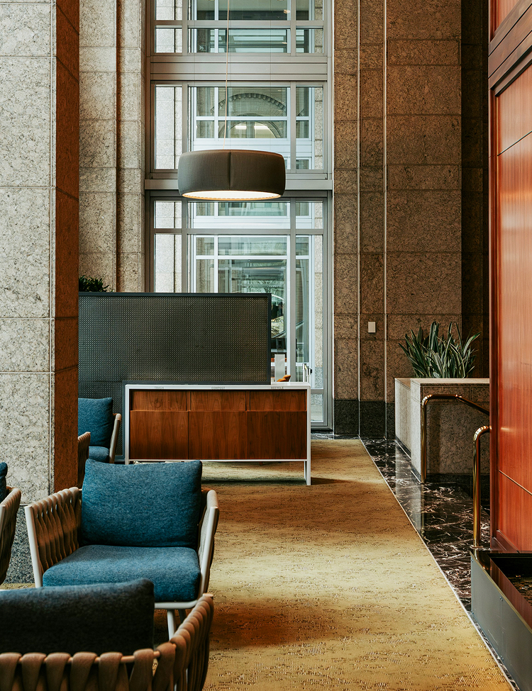 a lobby with a reception desk and chairs