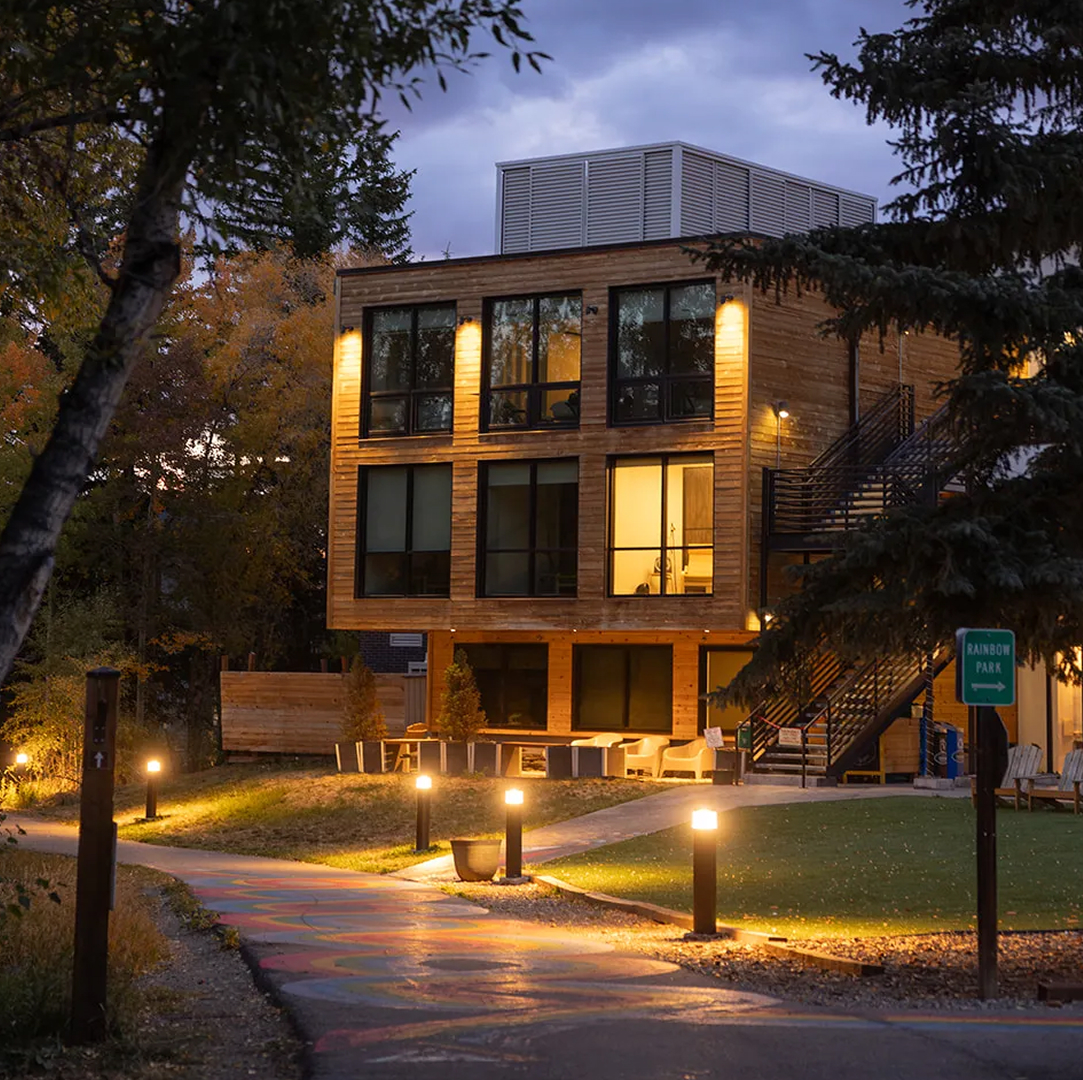 a building with lights on the side of it expanded