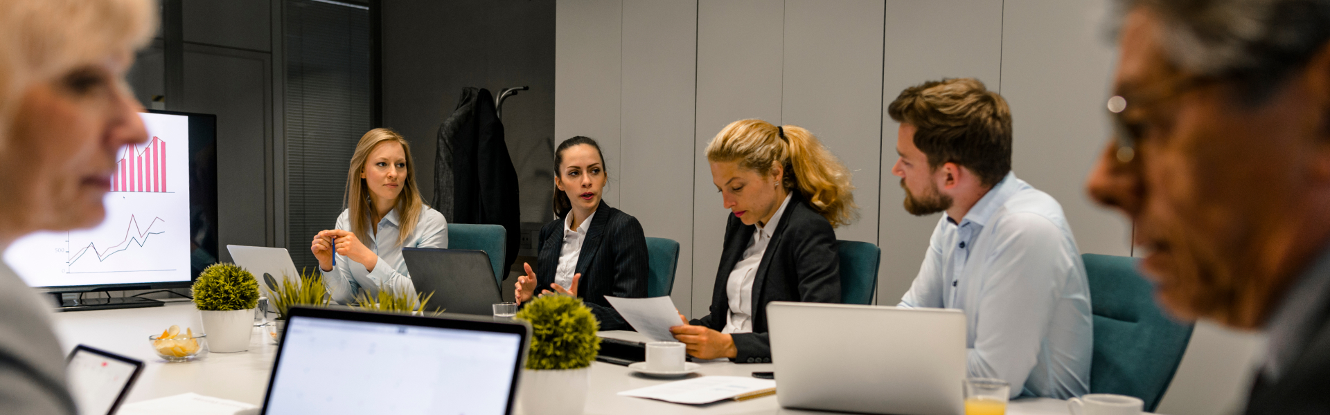 two women sitting at a table with papers