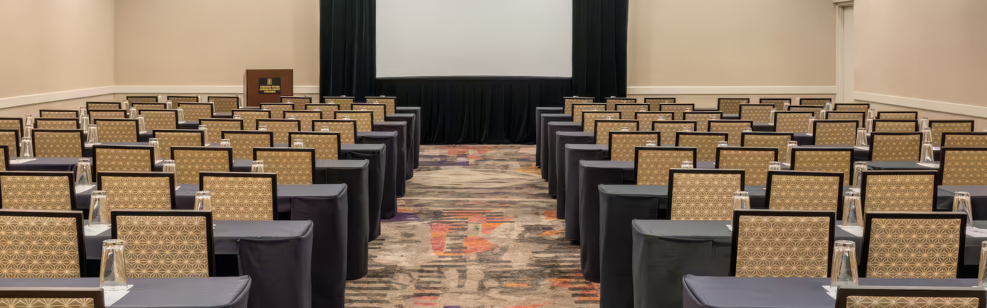 a room with chairs and a projector screen