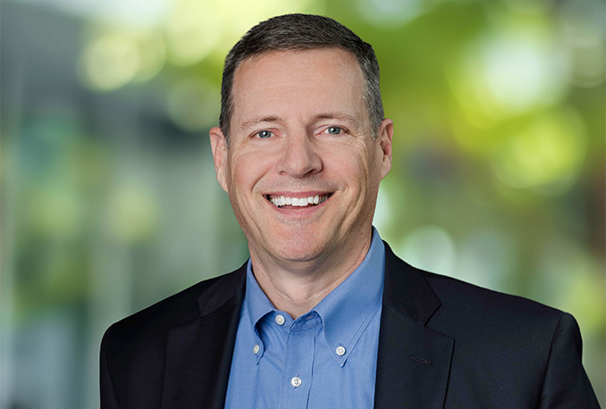 a man in a blue shirt smiling