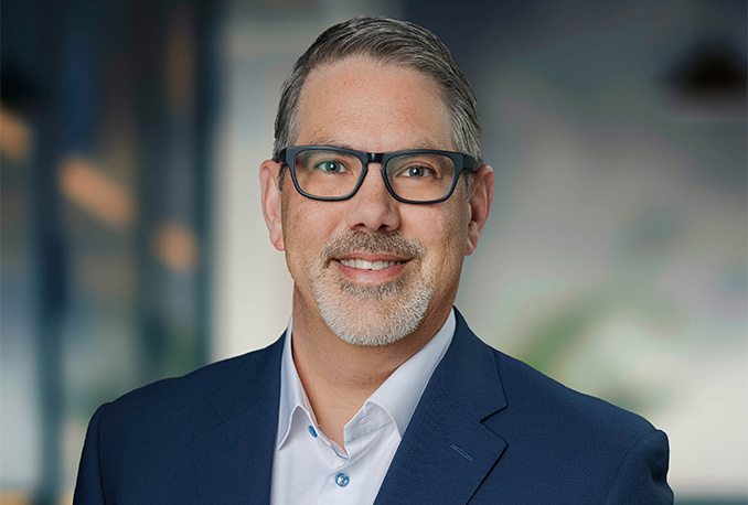 a man wearing glasses and a blue suit