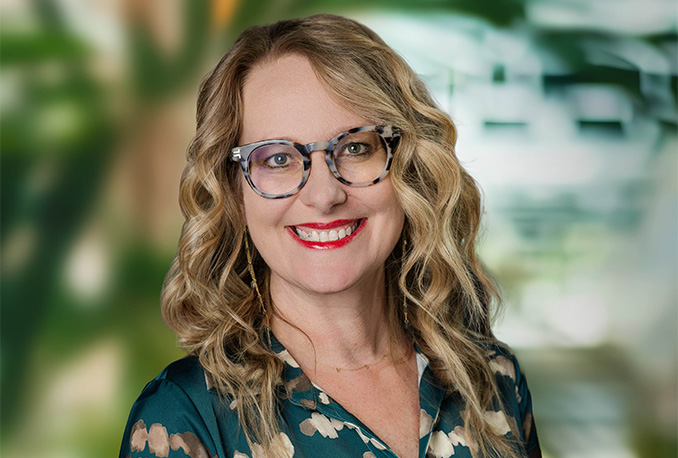a woman with blonde hair wearing glasses