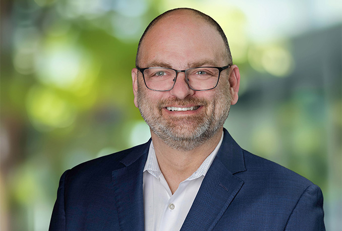 a man wearing glasses and a suit