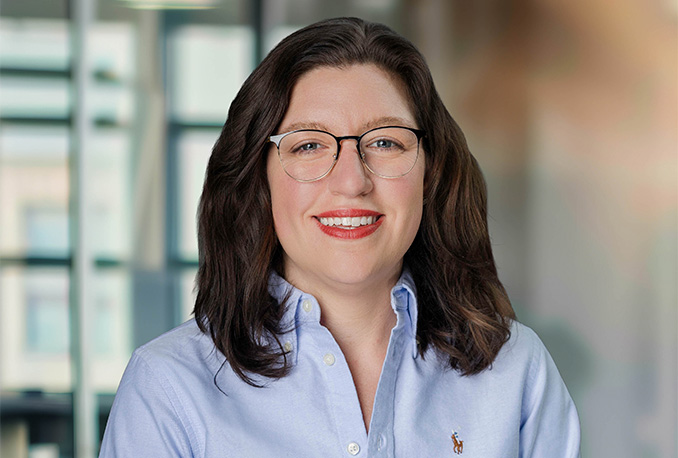 a woman wearing glasses and a blue shirt