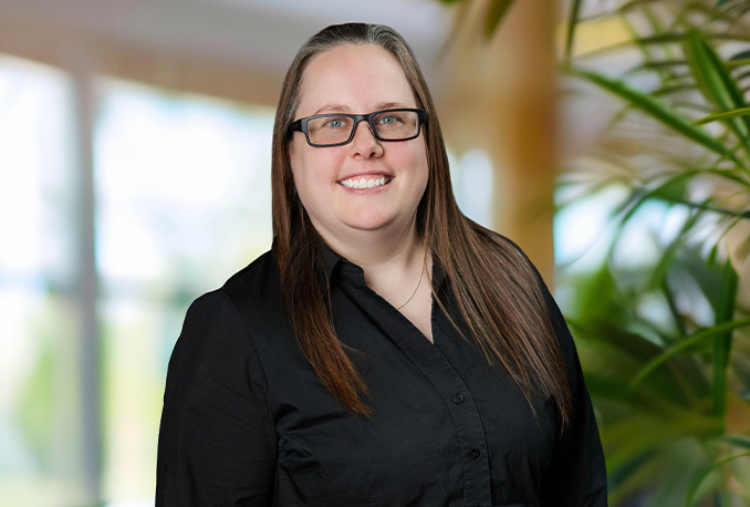 a woman wearing glasses and a black shirt