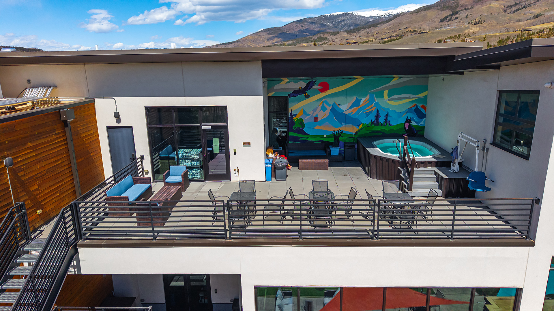 a balcony with a hot tub and a painting on the wall