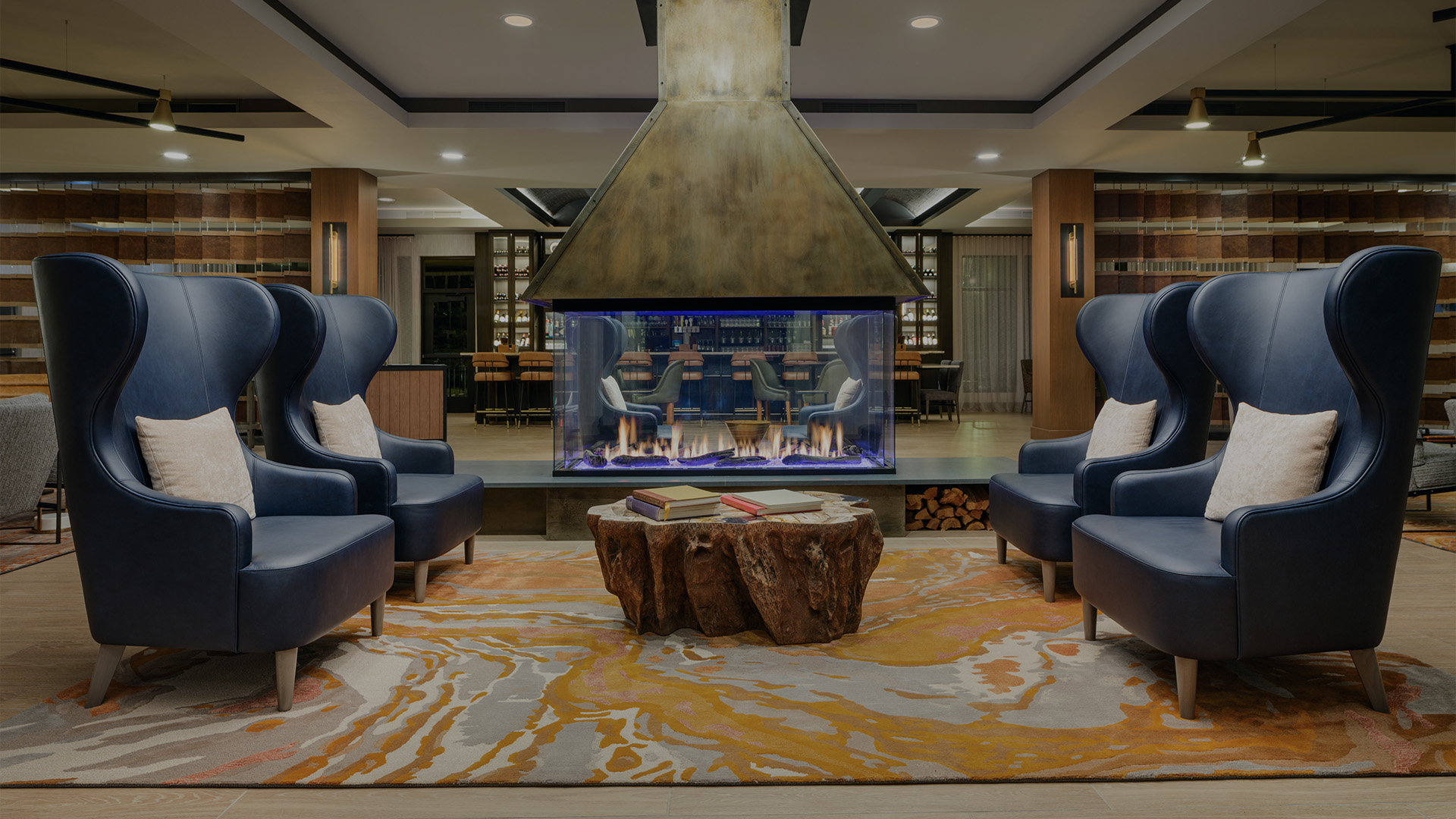 a room with a fireplace and chairs
