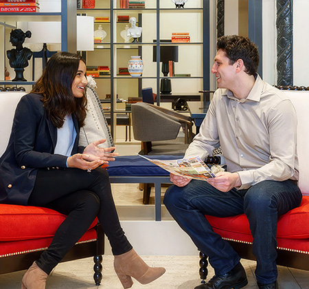 a man and woman sitting on chairs talking